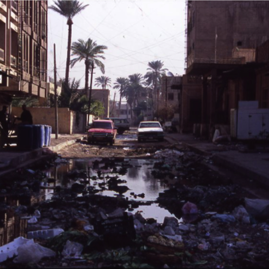 Trash filled street in Baghdad suburbs