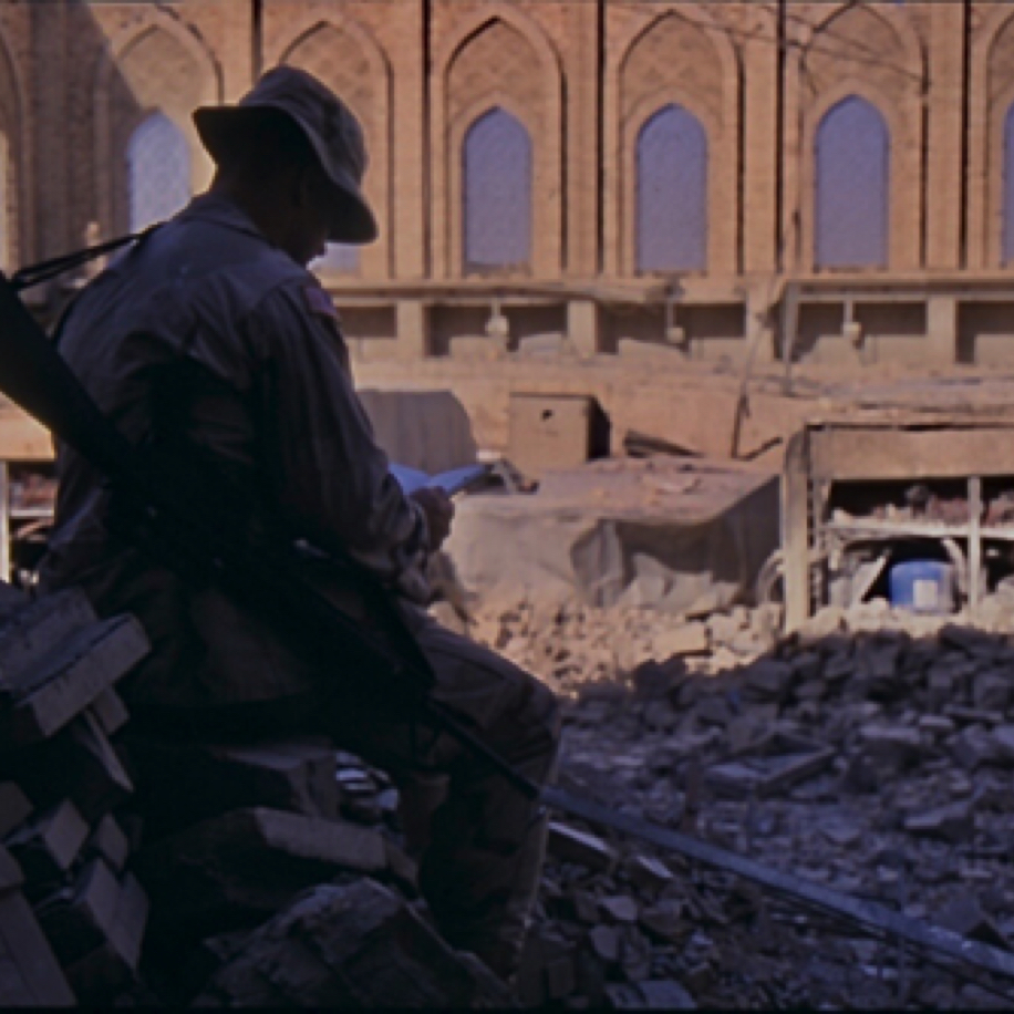 GI catching up on some reading in the ruins of one of Saddam's palaces